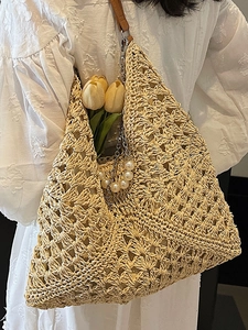 Large hand-woven straw tote bag with silver chain and pearl decoration for summer vacation