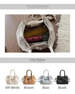Detail view of spacious lattice bucket bag interior holding a wallet and umbrella