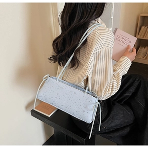 Rear view of a light blue star-pattern shoulder bag with drawstring side details
