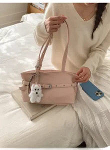 Détail du sac cabas rose avec boucle métallique et charmant petit chien en peluche