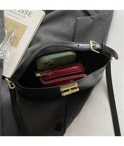 Internal view of minimalist black leather crossbody bag showing large storage capacity