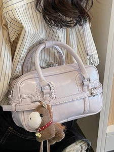 Lavender glossy faux leather bowling bag with decorative buckle and plush horse charm