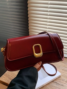 Deep red patent leather shoulder bag with gold metal buckle and vintage minimalist design