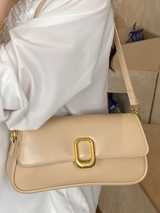 Elegant cream-colored minimalist square shoulder bag with gold textured buckle