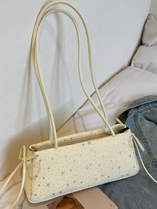 Chic cream rectangle shoulder bag featuring silver star patterns and bow detailing