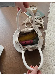 Top view of spacious cream canvas bucket bag interior showing daily essentials storage