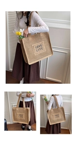 Gros plan du sac cabas tissé avec broderie LOVE LIFE et doubles bretelles d'épaule