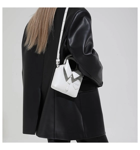 Vue détaillée du sac à bandoulière blanc en forme de chemise avec col et boutons