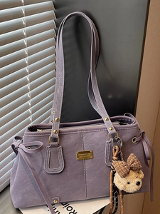 Chic purple faux leather tote bag for women featuring a cute plush bear charm with bow