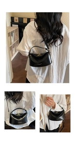 Detail of black matte leather handbag featuring vintage gold twist lock and semi-round handle