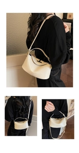 Detail of cream leather handbag with metal twist lock and fashion lettering engraving