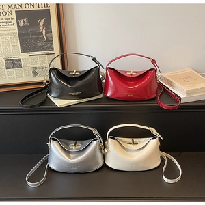 Detail view of stylish square handbags in black, burgundy, silver, and cream colors