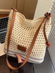Handwoven straw tote bag with blue stripes and brown leather straps for women