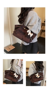 Detail view of large brown textured tote bag with slim straps and horse charm accessory