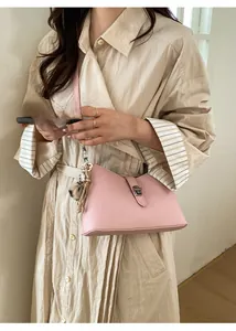 Pink lychee grain leather underarm bag with silver buckle and fur ball detail