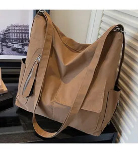 Detail view of the khaki large-capacity tote bag with zipper and durable side pockets