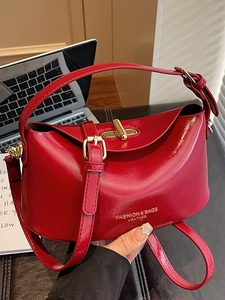 Elegant red leather handbag with gold twist lock and adjustable shoulder strap for women