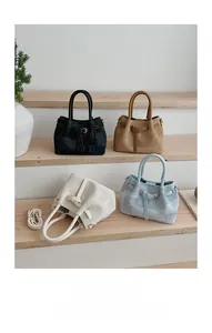 Detailed close-up showing textured jacquard fabric handbags in four assorted colors