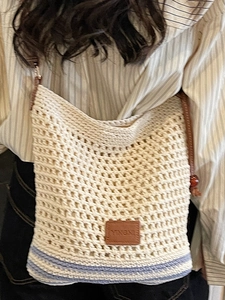 Handmade woven tote bag in creamy white cotton with blue stripes and leather logo