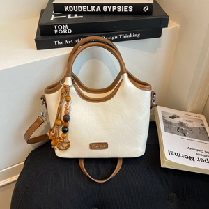 Close-up of cream bucket bag featuring lychee texture leather and colorful wooden beads
