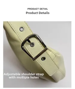 Detailed close-up of adjustable strap with silver buckle on the yellow leather moon bag