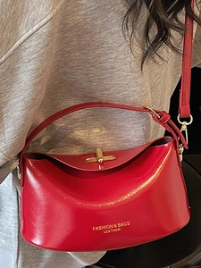 Elegant bright red semi-circle shoulder bag with gold rotating metal lock and red strap