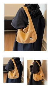 Detail view of khaki canvas tote bag featuring wave stitching and Docile-girl embroidery