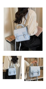 Detail of light blue denim-style backpack with star patterns and bow-shaped metal buckles