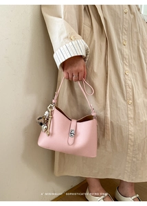 Pink lychee texture leather bag with silver buckle and decorative heart charms detail