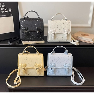 Detailed display of four color mini bags with star prints and bowknot buckle accents