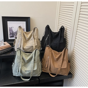 Assorted minimalist canvas shoulder bags in beige black green and brown colors
