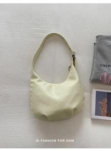 Close-up of beige vintage hobo bag showing premium leather texture and adjustable strap