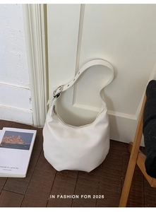 Detail of white hobo bag with high-quality leather texture and silver buckle