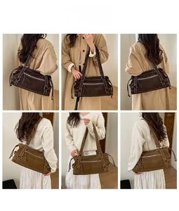 Detail view of large tote bags in brown and khaki green with Muon Shark embossed branding
