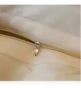 Close-up of smooth silver metal zipper and high-density canvas lining on woven bag