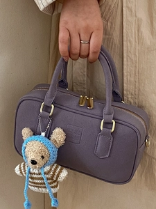 Purple suede Boston handbag with golden hardware and cute bear pendant accessory