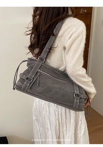 Detail of dark grey tote bag with white stitching and retro functional pockets
