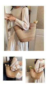Detail of striped woven straw tote bag with brown leather handles for beach vacation