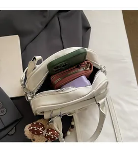 Interior view of white leather handbag showing large capacity for phone and wallet