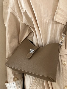 Taupe lychee grain leather bucket bag with silver lock and adjustable shoulder strap