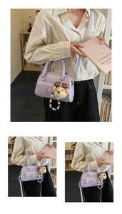 Detail of lavender patent leather handbag with a 3D bow and plush bear charm accessory