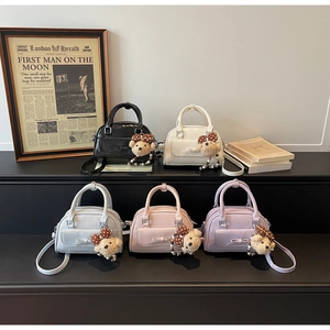 Mini Boston bags in five colors featuring bow details and plush bear charms
