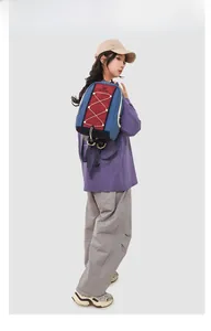 Outdoor leisure backpack with color-blocking design and elastic cords shown on model