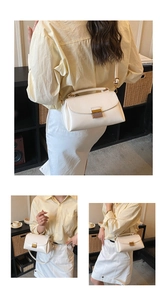 Détail d'un sac bandoulière blanc crème en cuir avec fermoir métallique et sangle