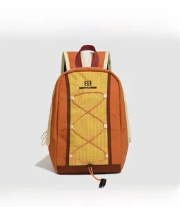 Detail of outdoor backpack featuring orange contrast colors and elastic drawstring system
