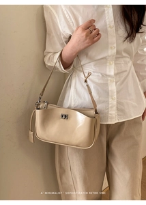 Close-up of cream vintage baguette bag with silver metallic clasp and minimalist design
