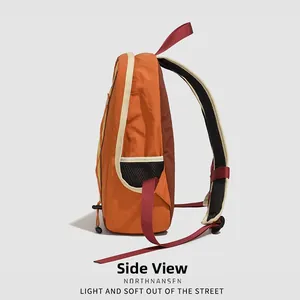 Side view of multi-color nylon backpack with mesh pockets and adjustable red straps
