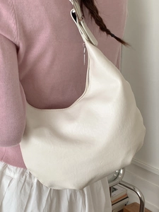 Minimalist cream white crescent hobo bag made of soft matte leather with adjustable strap
