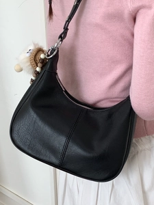 Sac à bandoulière demi-lune noir en similicuir avec un pendentif poupée au crochet artisanal