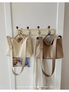 Detail view of vintage minimalist leather tote bags in cream and khaki colors